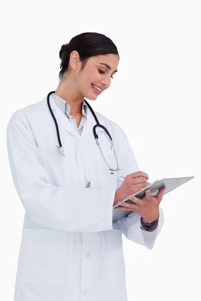 Side view of female doctor taking notes — Stock Photo, Image