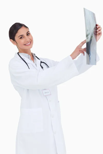 Side view of smiling female doctor holding x-ray — Stock Photo, Image