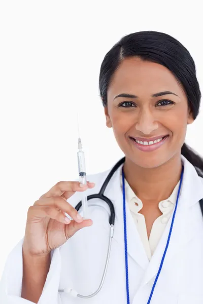 Zbliżenie uśmiechający się kobiece kobieta lekarz z strzykawka — Zdjęcie stockowe