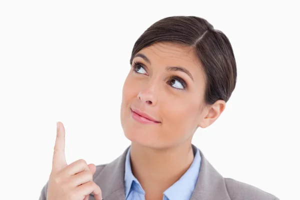 Close up of female entrepreneur pointing and looking up — Stock Photo, Image