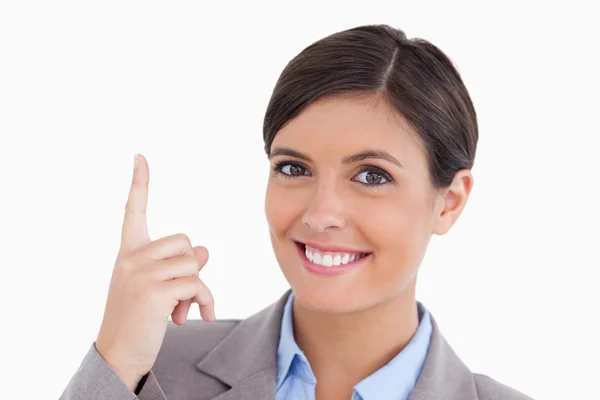 Close up of smiling female entrepreneur pointing up — Stock Photo, Image