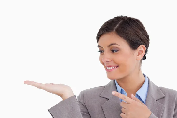 Close up of female entrepreneur looking and pointing at her palm — Stock Photo, Image