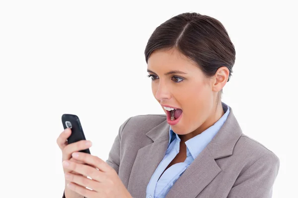 Close up of female entrepreneur surprised by text message — Stock Photo, Image