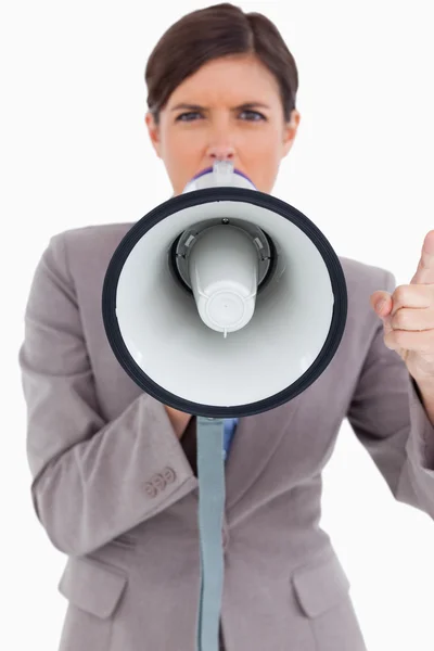 Close up of angry female entrepreneur shouting through megaphone — Stock Photo, Image