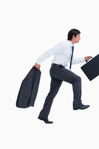 Side view of sprinting businessman with suitcase and jacket — Stock Photo, Image