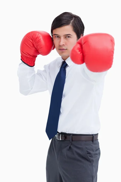 Young tradesman with boxing gloves striking — Stock Photo, Image