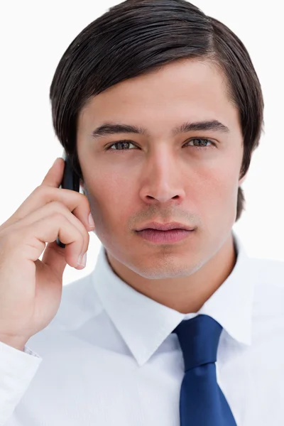 Close up of serious tradesman on his cellphone — Stock Photo, Image
