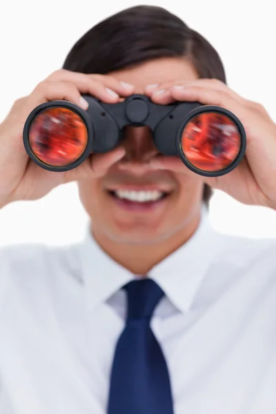 Close up of smiling tradesman looking through spy glass — Stock Photo, Image