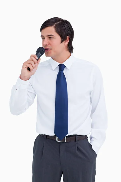 Close up of young tradesman talking with microphone — Stock Photo, Image
