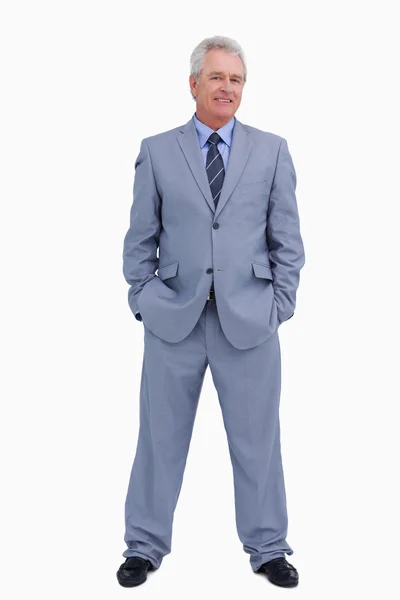 Smiling mature tradesman with hands in his pockets — Stock Photo, Image