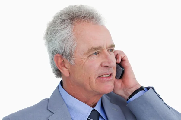Close up side view of mature tradesman on his cellphone — Stock Photo, Image