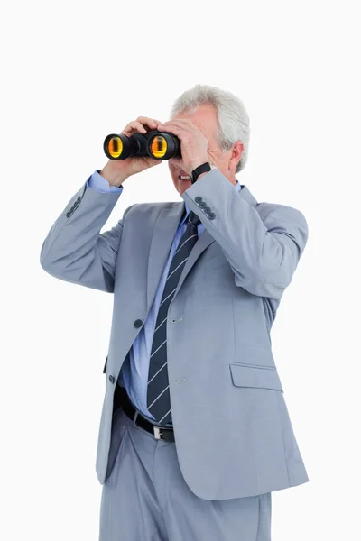 Mature tradesman looking through spy glass — Stock Photo, Image