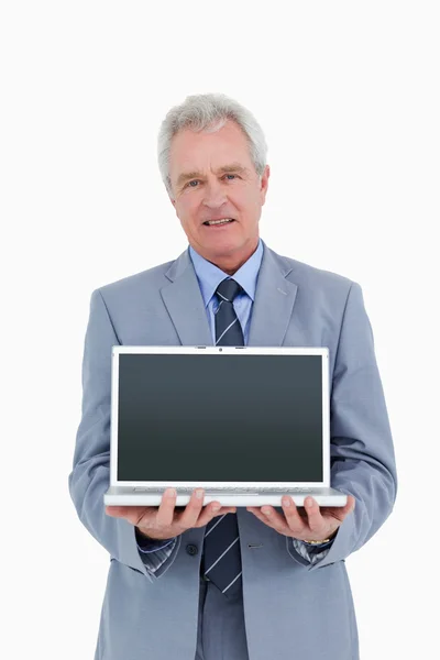 Mature tradesman presenting screen of his laptop — Stock Photo, Image