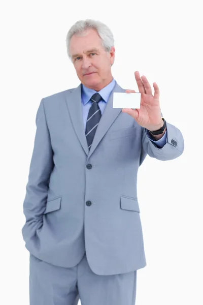 Mature tradesman presenting his business card — Stock Photo, Image