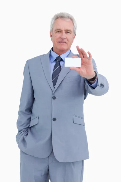 Mature tradesman showing his business card — Stock Photo, Image