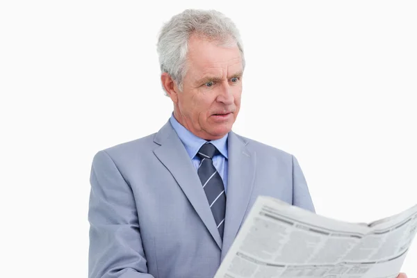 Mature tradesman surprised by the news paper — Stock Photo, Image