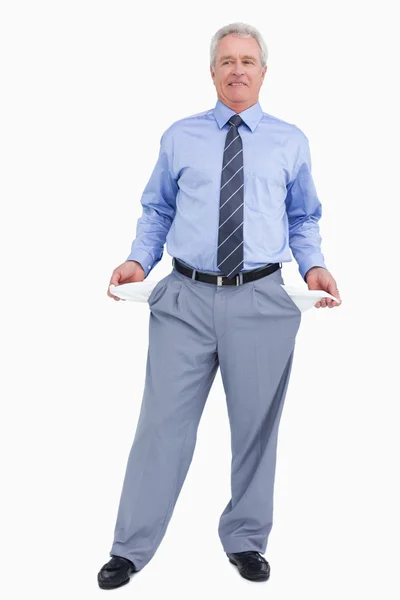 Mature tradesman showing his empty pockets — Stock Photo, Image