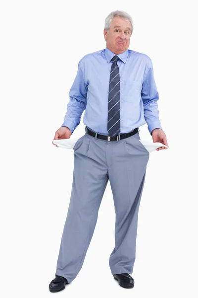 Clueless mature tradesman showing his empty pockets — Stock Photo, Image