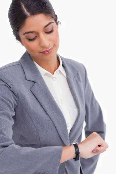 Close up of female entrepreneur looking at her watch — Stock Photo, Image