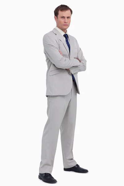 Serious businessman standing with his arms folded — Stock Photo, Image