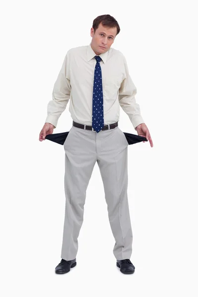 Sad businessman showing his empty pockets — Stock Photo, Image