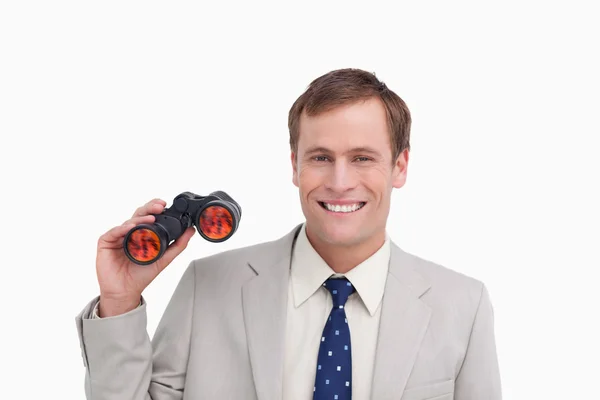Smiling businessman with spy glasses — Stock Photo, Image