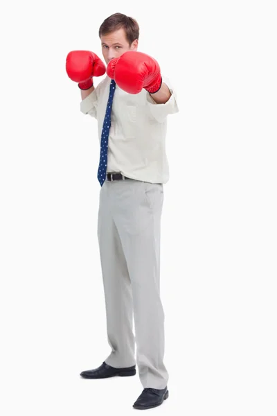 Empresário com luvas de boxe em posição ofensiva — Fotografia de Stock