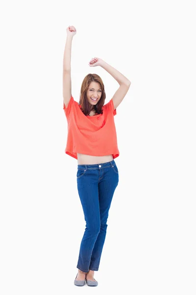 Casual teenager raising her arms above her head — Stock Photo, Image