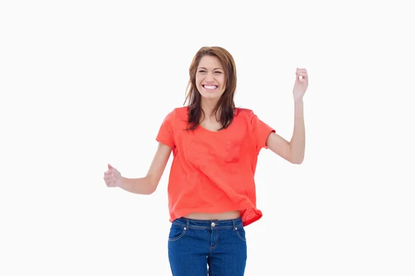 Teenager giggling with arms raised — Stock Photo, Image