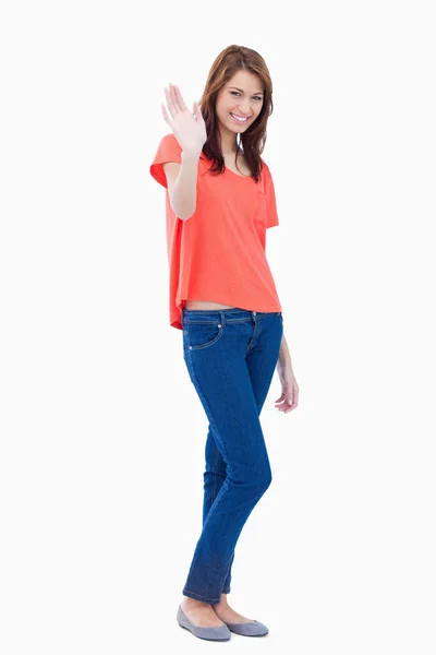 Young woman raising her hand as a greeting — Stock Photo, Image