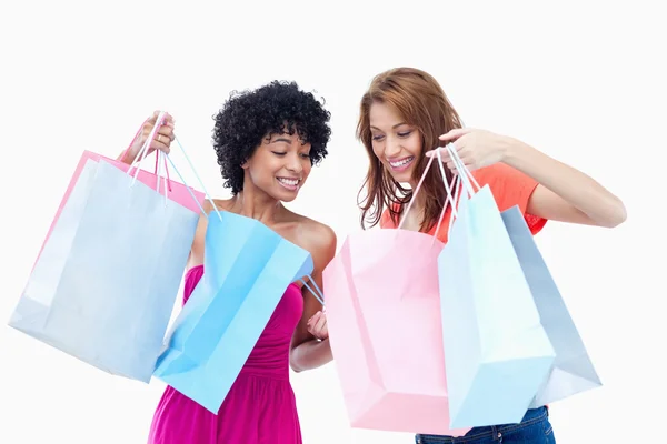 Teenage girls looking at each others purchases — Stock Photo, Image