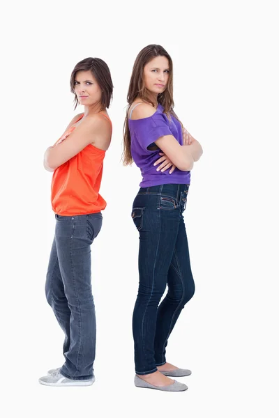 Teenage girls wearing casual clothes while standing back to back — Stock Photo, Image