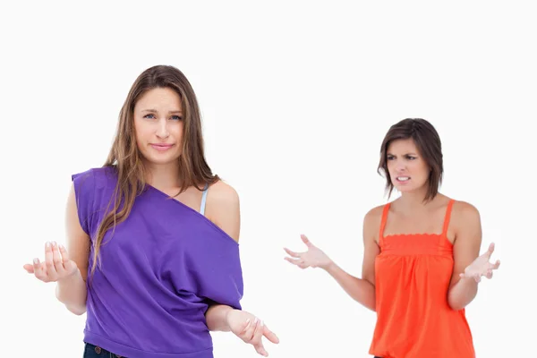Teenage girl wondering why her friend is angry at her — Stock Photo, Image