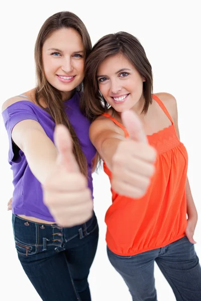 Smiling teenagers giving their thumbs up in approval — Stock Photo, Image