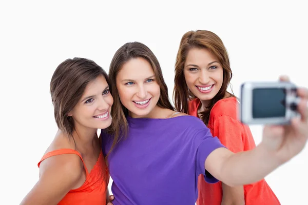 Three beautiful teenagers showing beaming smile in front of the — Stock Photo, Image