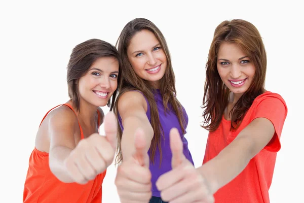 Happy teenagers standing side by side with their thumbs up — Stock Photo, Image
