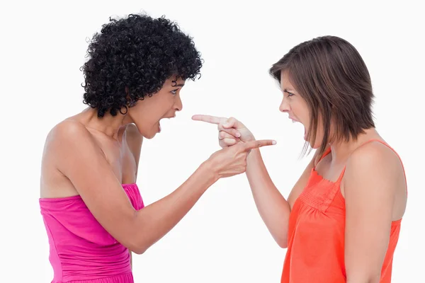 Angry teenage girls standing face to face and pointing their fin — Stock Photo, Image