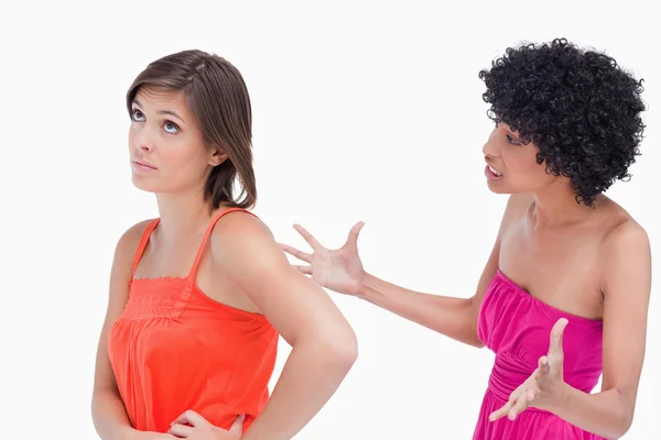 Upset teenager roaring at a friend against a white background — Stock Photo, Image