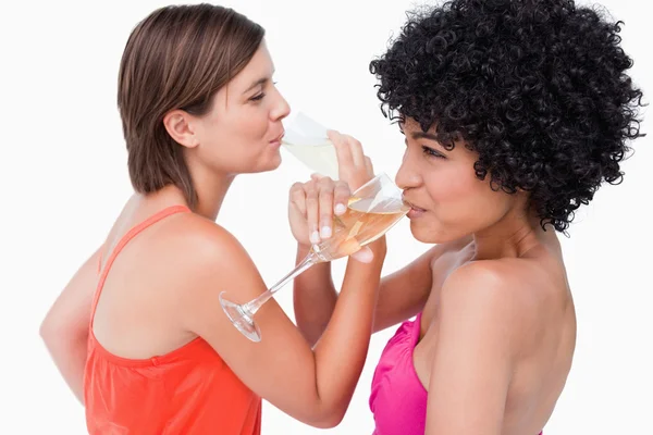 Young women crossing their hands together while drinking champag — Stock Photo, Image