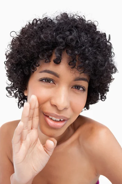 Young woman whispering against a white background — Stock Photo, Image