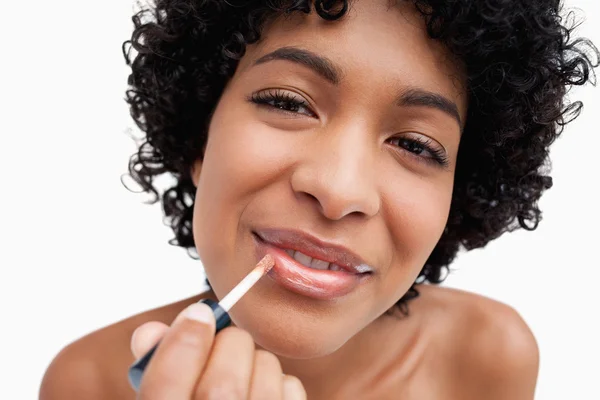 Beautiful young woman using lip brush while making-up — Stock Photo, Image