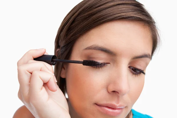 Relaxed teenager carefully applying her mascara on her eye — Stock Photo, Image