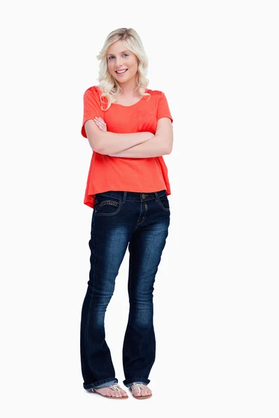 Smiling teenager crossing her arms while standing upright — Stock Photo, Image