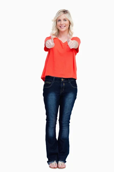 Smiling fair-haired teenager proudly showing her thumbs up — Stock Photo, Image