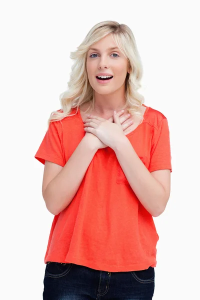 Teenager looking surprised while crossing her hands on her chest — Stock Photo, Image