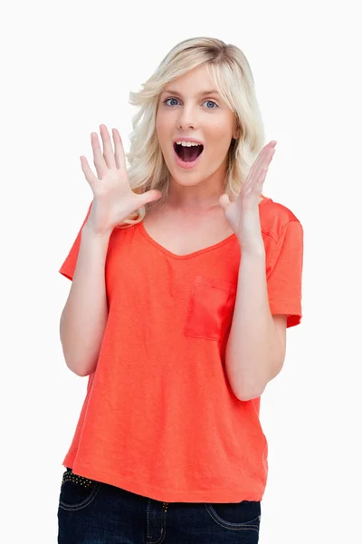 Surprised teenager standing upright with her arms next to her he — Stock Photo, Image