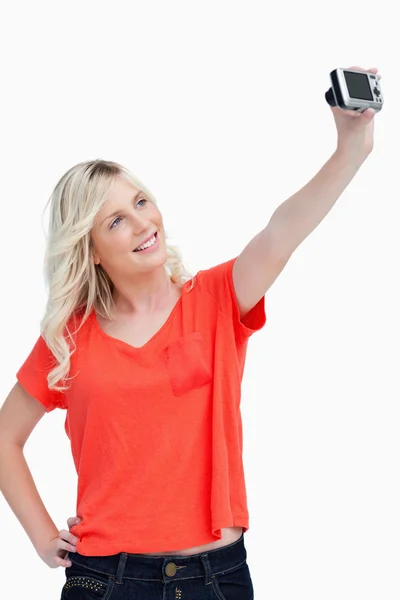Smiling teenager posing in front of her digital camera — Stock Photo, Image