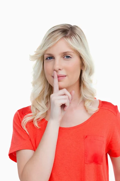 Beautiful woman looking at the camera while telling to be quiet — Stock Photo, Image