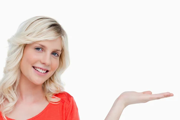 Smiling woman putting her hand palm up — Stock Photo, Image