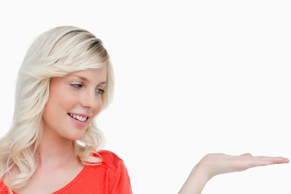 Smiling woman looking at her hand palm up — Stock Photo, Image